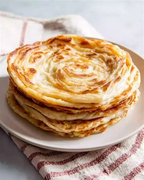 Fresh lachha paratha stacked and ready to serve